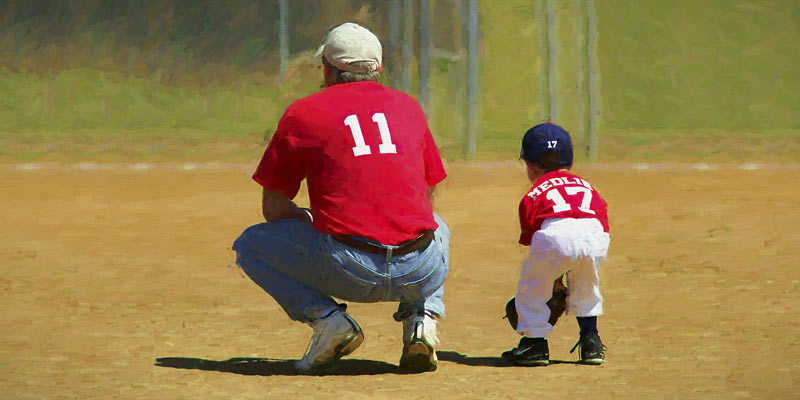 Baseball coach with young boy