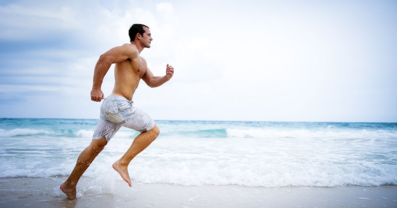 Male Athlete Running on Beach
