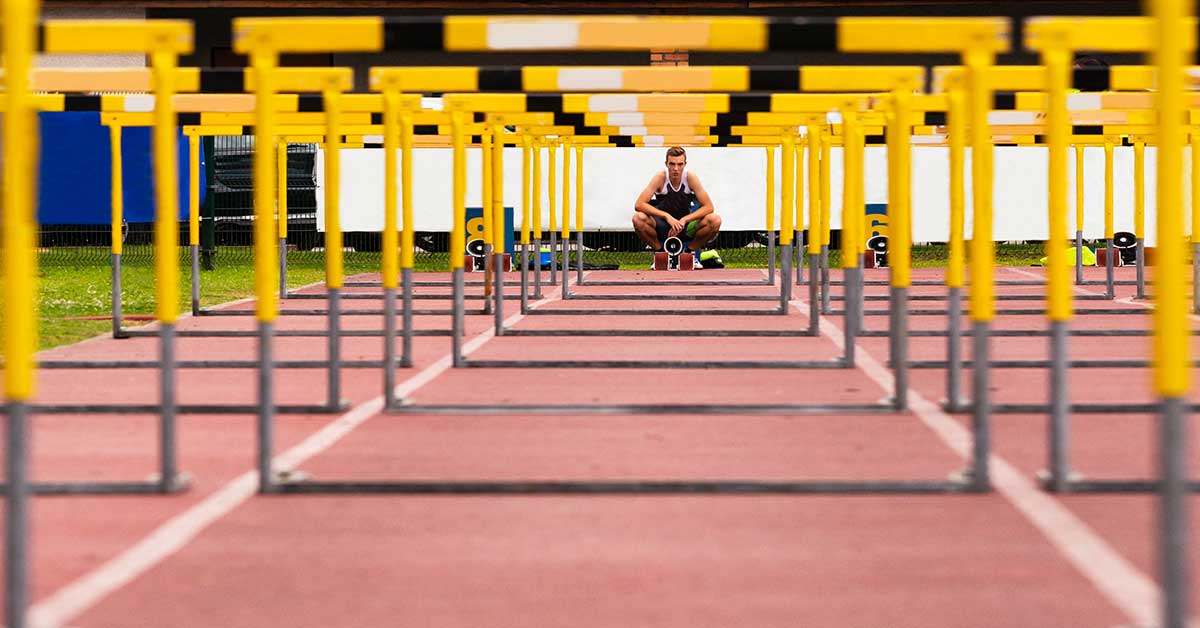 Athlete Looking Through Hurdles