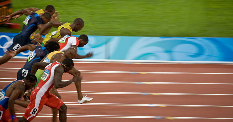 Athletes in motion at the start of a sprint race