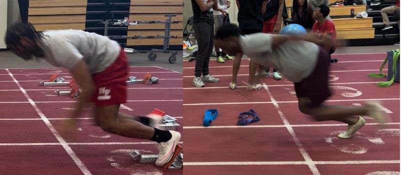 Two athletes in motion at the starting blocks on an indoor track, wearing athletic gear. They appear to be sprinting as others watch in the background. Various sports equipment is scattered around.