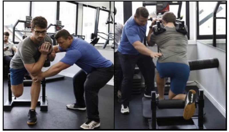 Dr. Pat Davidson works with athlete using Keiser resistance training tools.