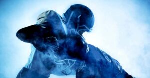American Football In-Season Training|Football Training Template|Football In-Season Loading|NFL Wide Receiver Max Velocity|Lateral Leg Option|A person with curly hair is on their hands and knees on a red carpet