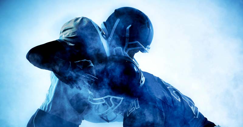 American Football In-Season Training|Football Training Template|Football In-Season Loading|NFL Wide Receiver Max Velocity|Lateral Leg Option|A person with curly hair is on their hands and knees on a red carpet