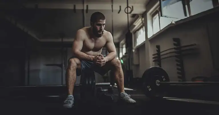 Athlete in Weight Room|Grip Strength Sequence|Eye Charts|A person in a gym is undergoing a training exercise using a pulley system. Theyre holding a rope attached to the frame