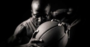 Baskeball Player with Ball|Omegawave HRV|Coop Lifting|Omegawave-Athlete-Assessment|Preparedness Curve|Tablet display showing an app interface with a profile of a user named John Smith. The screen features a line graph labeled Central Nervous System - DC Curve