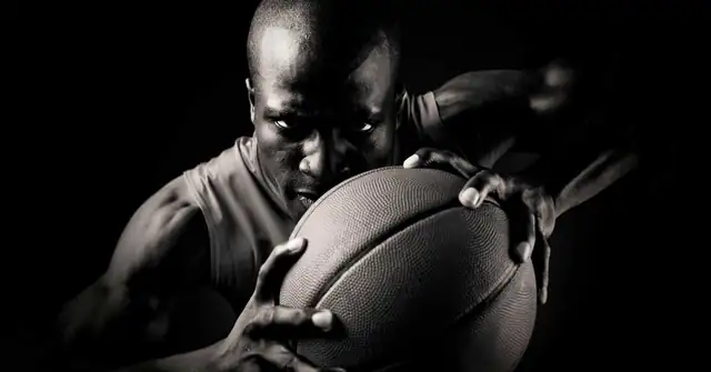 Baskeball Player with Ball|Omegawave HRV|Coop Lifting|Omegawave-Athlete-Assessment|Preparedness Curve|Tablet display showing an app interface with a profile of a user named John Smith. The screen features a line graph labeled Central Nervous System - DC Curve