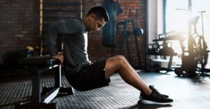Male athlete performing a chair dip|Tricpes