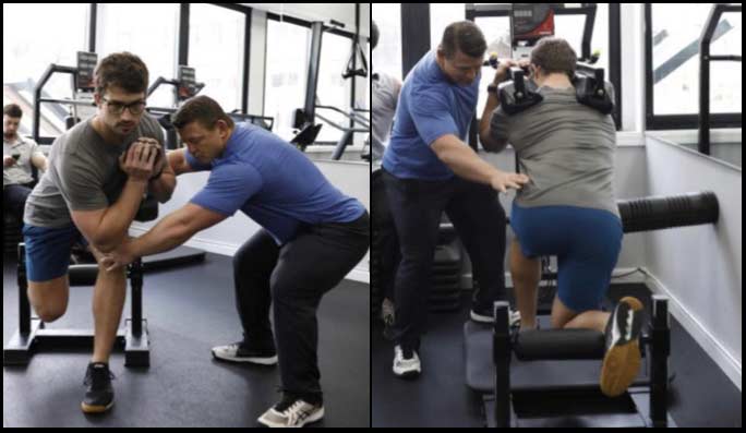 Coach in gym cueing his athlete's lifts.