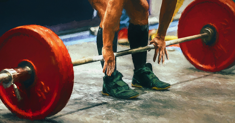 Deadlift Barbell and Weights|Steve Desitter and Barry Ross|Barry Ross Project Day One|Barry Project Plyometrics|A person is running on a red track with a grassy area in the foreground. Two small cones are placed on the track. Behind the track
