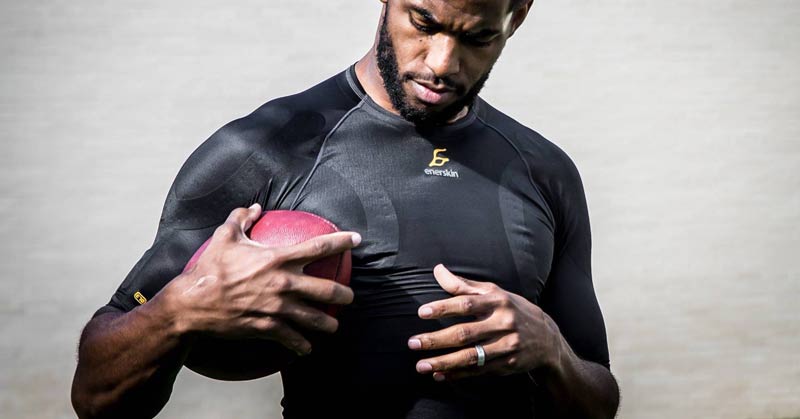 Enerskin|BSX Insight|SkinTech|Hexoskin|Close-up of a muscular arm wearing a black compression sleeve with dotted patterns