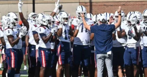 FAU Team|A man in a suit and tie smiles at the camera