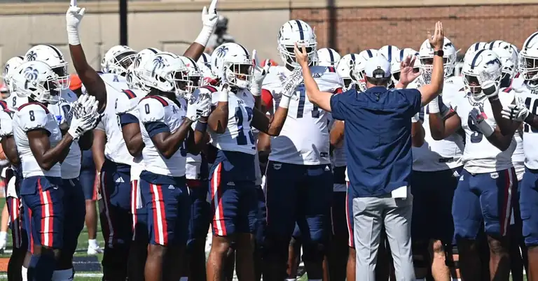 FAU Team|A man in a suit and tie smiles at the camera