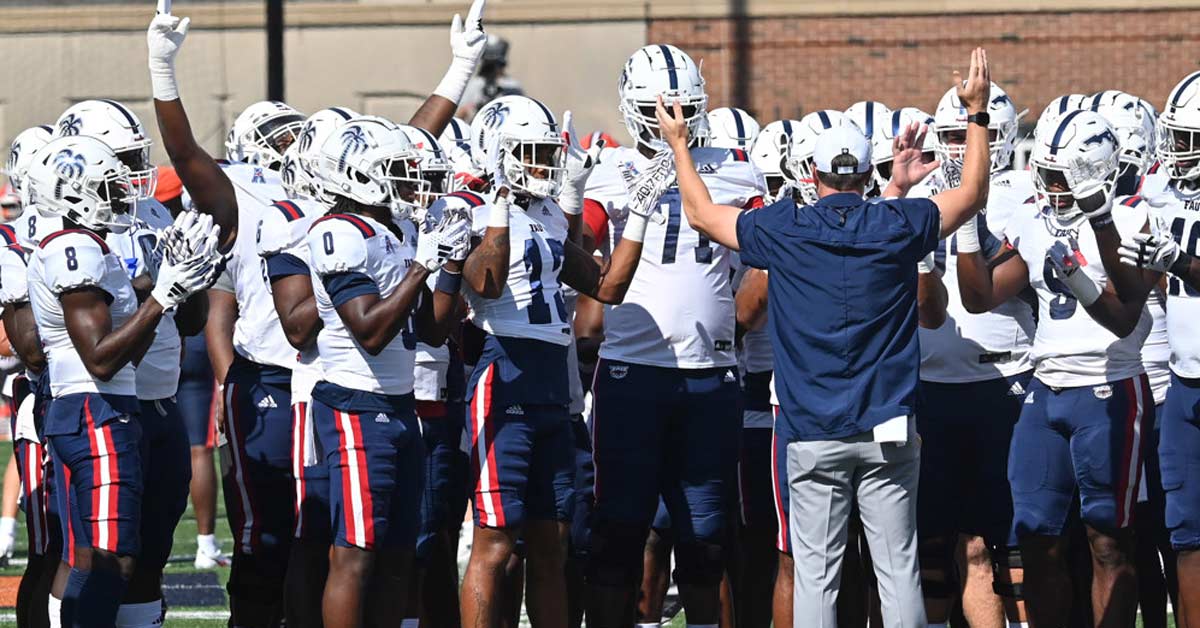 FAU Team|A man in a suit and tie smiles at the camera