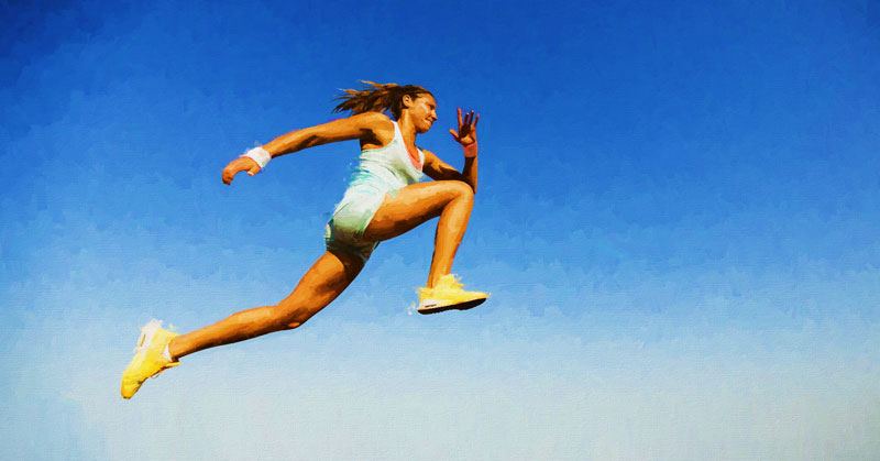 Female Long Jumper|Velocity Characteristics Among the Jumps|Velocity Characteristics in Sprinting|Relationship Between Force and Velocity|Force Velocity Curve for Resisted and Assisted Jumping|Assisted Jumps Device|Assisted Jumps Device|A person in a gym performs a squat using TRX suspension straps. They are wearing a gray hoodie