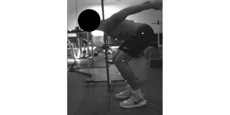 A person is performing a bent-over barbell row exercise in a gym. They are leaning forward with knees slightly bent. The image highlights body alignment and posture, with dots marking key points along the body. Equipment is visible in the background.
