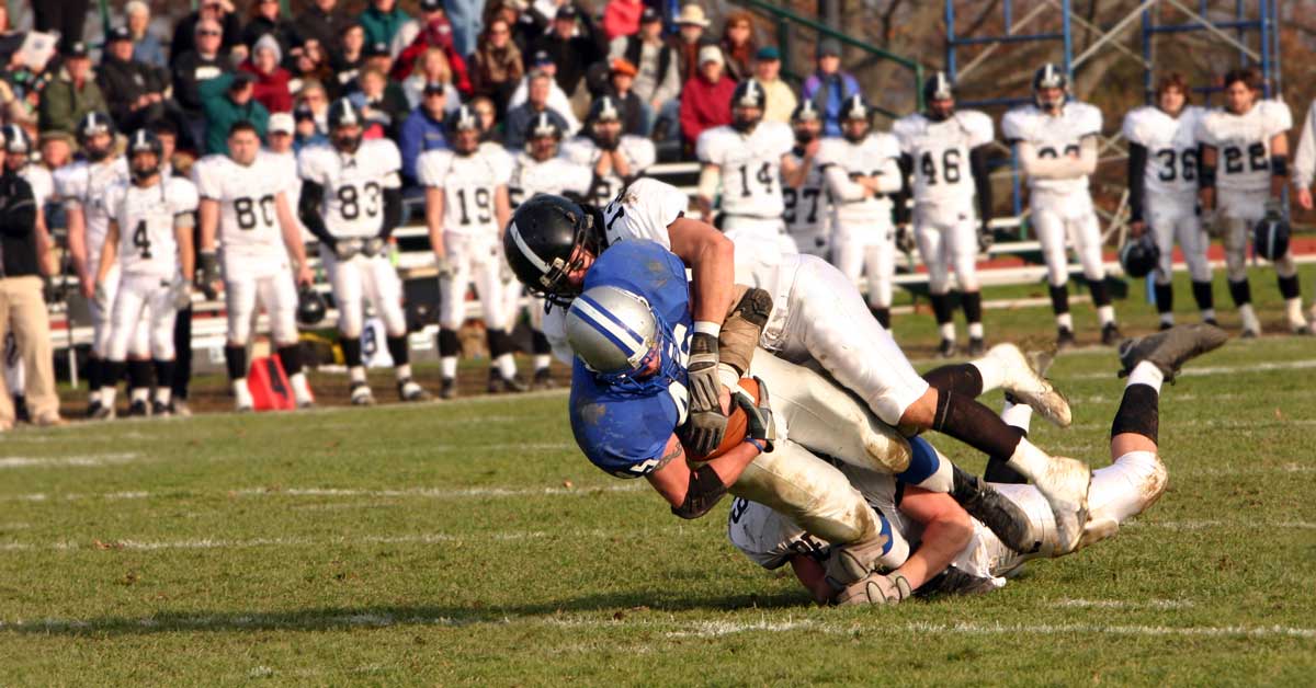 Football Tackle|A pair of medical compression leg sleeves are laid out on a table. The sleeves