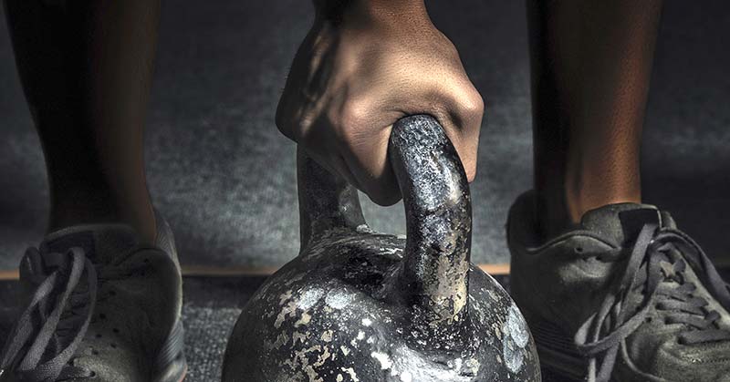 Kettle Bell|A person performs an exercise outdoors