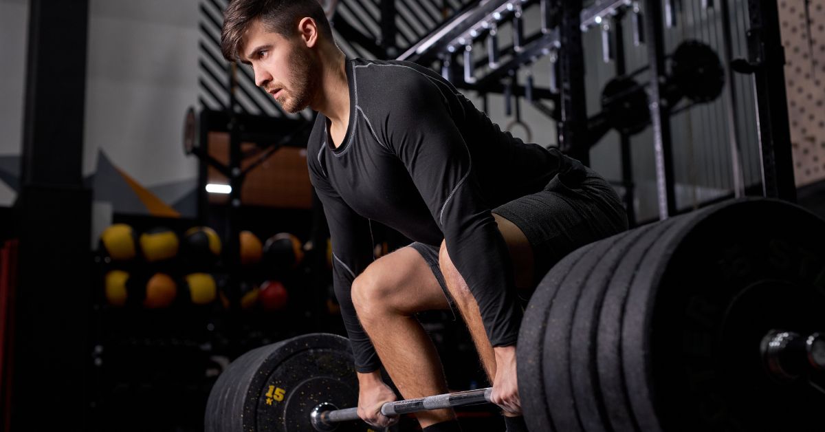 VBT Powerlifting|Enode Pro|An athlete loading weights onto a bar.