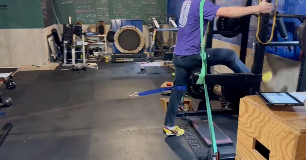 Athlete performs Yuri exercise to develop horizontal force in early acceleration phase of a sprint.|A person in motion