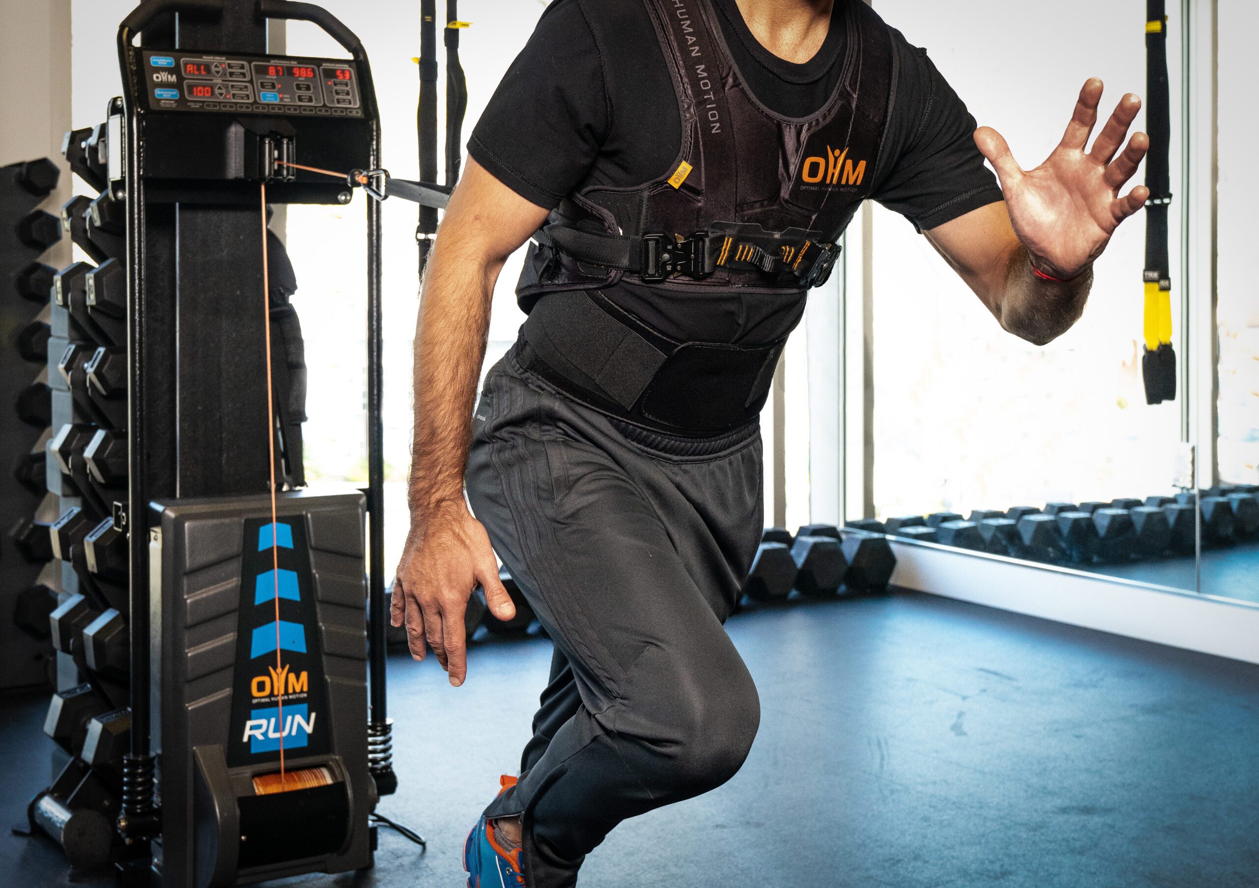 Athlete performs resisted exercise using OHM Run training technology.