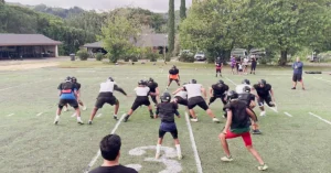 Power|Angles of Movement|Football game scene showing players lined up on the field. One player in yellow is highlighted. The team in red and white is facing the team in white and yellow. A Championship Productions logo is visible in the top right corner.|Football play diagram showing offensive and defensive player positions and movements on a field. The offense (O
