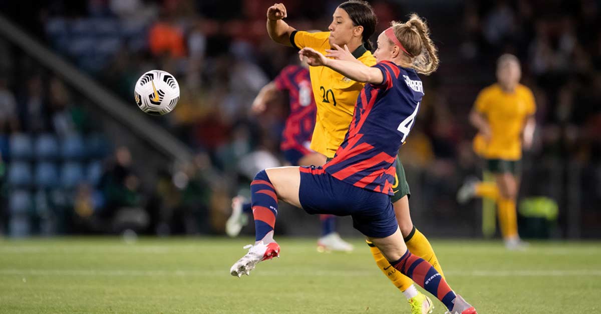 Sauerbrunn Multisport|Wambach Header|Cards Autographs|Pitcher Center Back|Goal Keeper running the bases|Multisport Twins|Top: Girls playing soccer on a field. Middle: A girl in maroon and gold softball gear batting at a softball game. Bottom: A girl in a white and maroon jersey preparing to catch a football during a game.