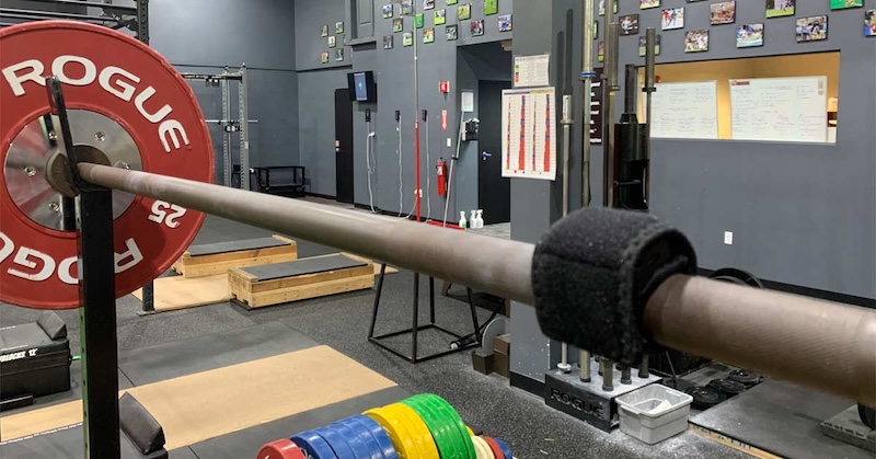 The Enode Pro strapped to a barbell.
