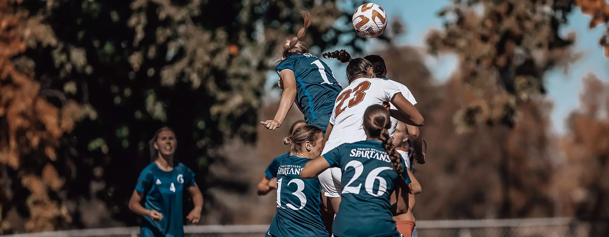 A group of women playing football

Description automatically generated