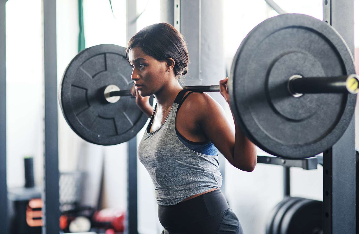 A person lifting weights in a gym

Description automatically generated