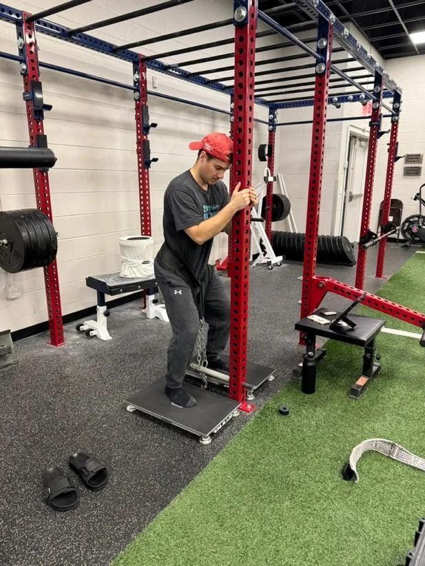A person standing on a platform in a gym

AI-generated content may be incorrect.