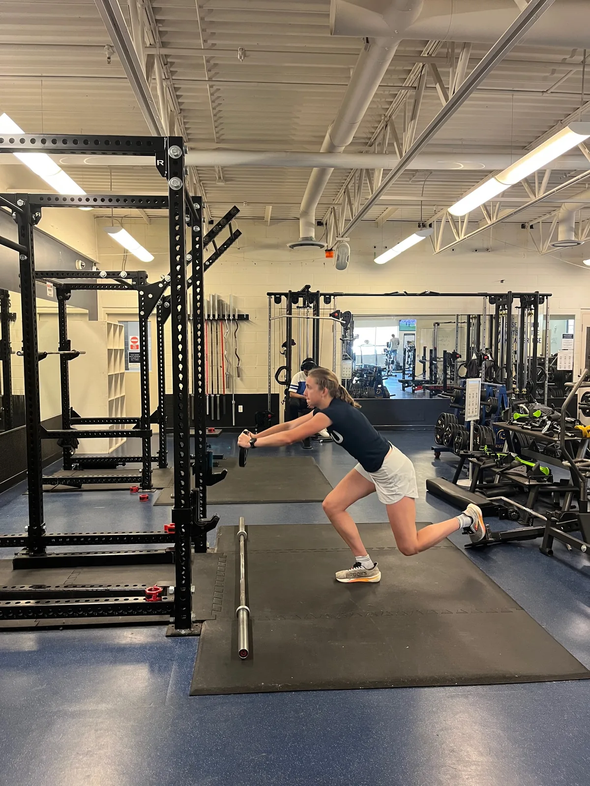An athlete performs a single-leg strength and balance drill in the weight room.